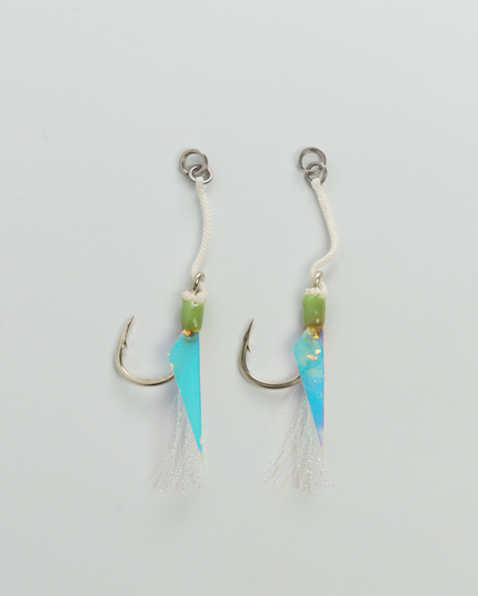 Two fishing lures with blue and green blades on a light gray background